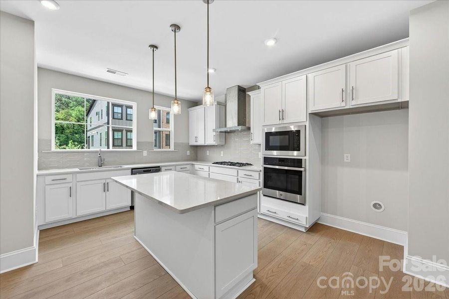 Gourmet kitchen with white cabinets and white quartz countertops Gourmet kitchen with white cabinets and white quartz countertops