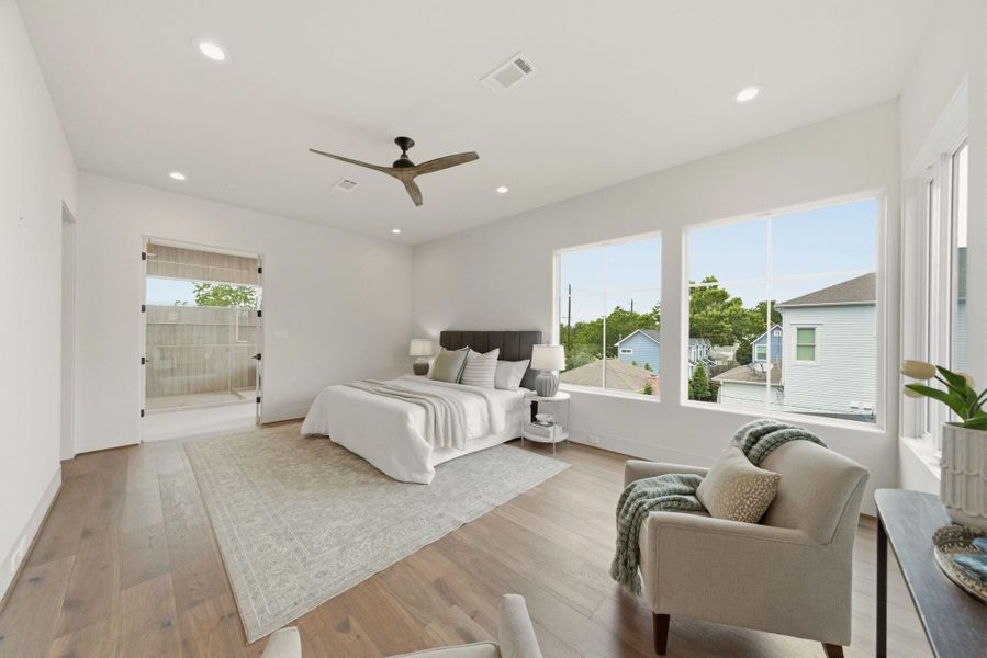 Spacious primary suite featuring a private sitting area and serene tree-lined views.
