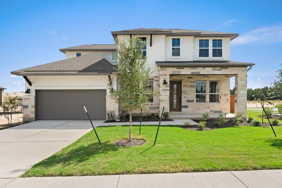 Front exterior of a new home in Lariat, Liberty Hill, TX, highlighting curb appeal (Image 1). Front exterior of a new home in Lariat, Liberty Hill, TX, highlighting curb appeal (Image 1).