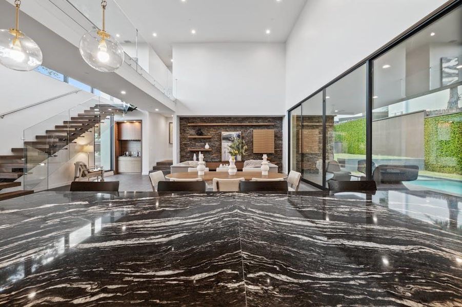 our extraordinary kitchen, featuring a substantial granite island and state-of-the-art appliances. This culinary haven is designed for both functionality and aesthetics, offering a spacious granite countertop that serves as a focal point for cooking and gathering.