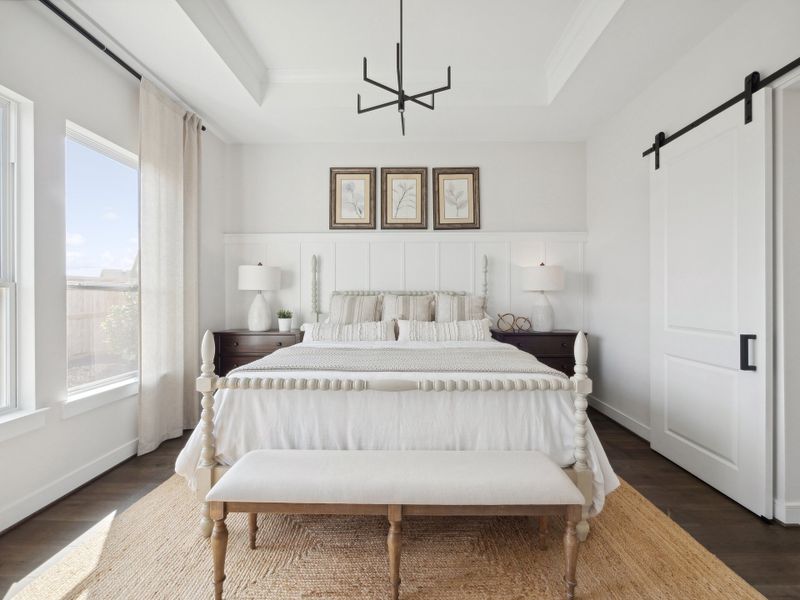 Primary suite with decorative feature wall and chandelier Primary suite with decorative feature wall and chandelier