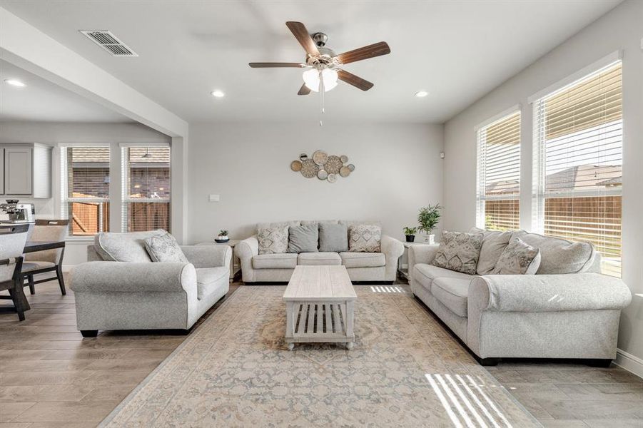 Living room featuring recessed lighting, ceiling fan, and light wood-type flooring