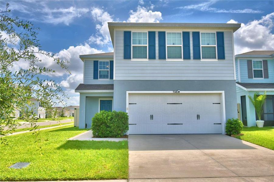 Front exterior of a new home in , Haines City, FL, highlighting curb appeal (Image 2). Front exterior of a new home in , Haines City, FL, highlighting curb appeal (Image 2).