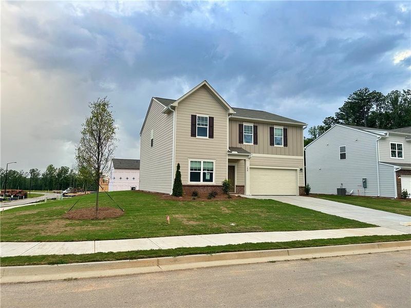 Front exterior of a new home in Mt. Tabor Ridge, Dallas, GA, highlighting curb appeal (Image 14). Front exterior of a new home in Mt. Tabor Ridge, Dallas, GA, highlighting curb appeal (Image 14).