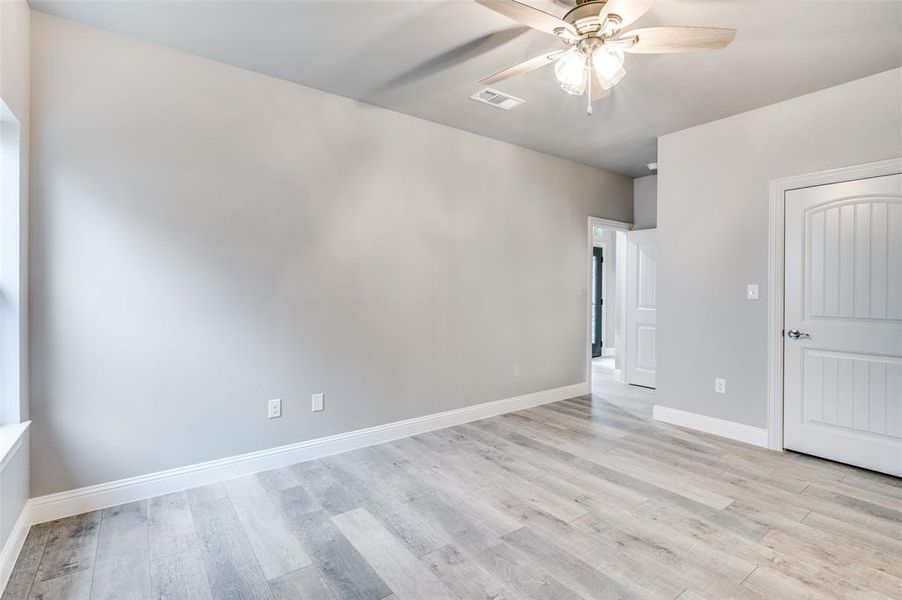 Empty room featuring ceiling fan and light hardwood / wood-style flooring