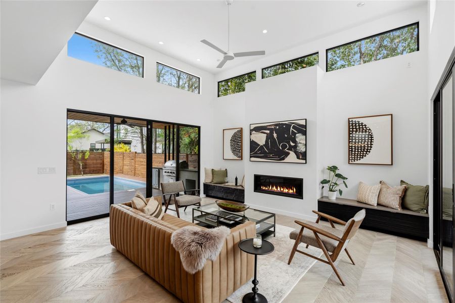 Living room has light from each end and over looks the private pool