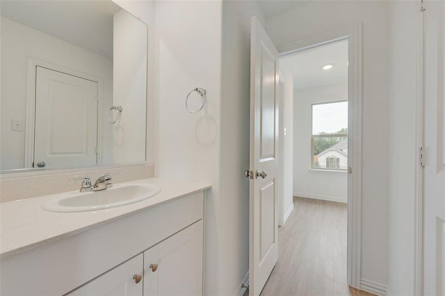 Bathroom with vanity and hardwood / wood-style flooring