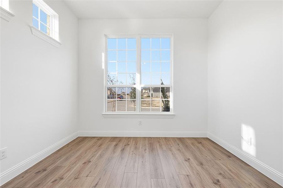 Unfurnished room with light wood-type flooring and baseboards Unfurnished room with light wood-type flooring and baseboards
