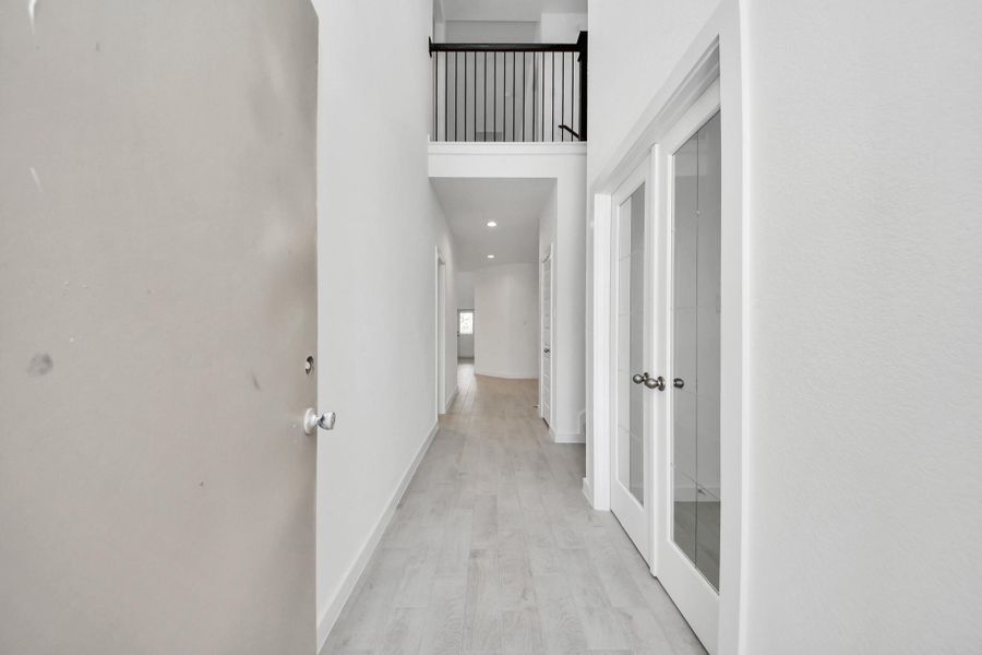 As you step into the threshold of this luxurious home, you'll soon be welcomed by an elegant glass door (to be installed). Inside, soaring ceilings amplify the spaciousness, while the refined wood-look tile flooring and oversized baseboards exude sophistication and charm. Sample photo of completed home with similar floor plan. Actual colors and selections may vary.