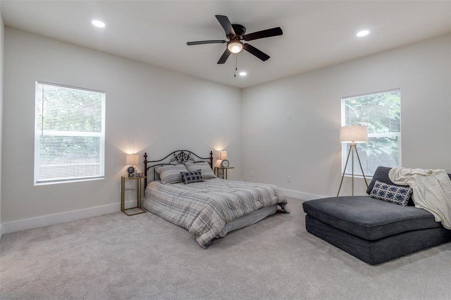 Bedroom featuring ceiling fan and light colored carpet