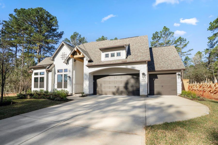 Front exterior of a new home in The Woodlands Hills, Willis, TX, highlighting curb appeal (Image 20).