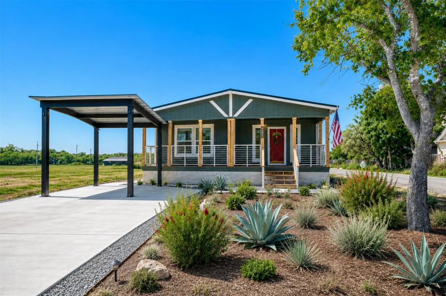 A striking contemporary home with a vibrant red door and carport, set against a backdrop of natural landscaping. A striking contemporary home with a vibrant red door and carport, set against a backdrop of natural landscaping.
