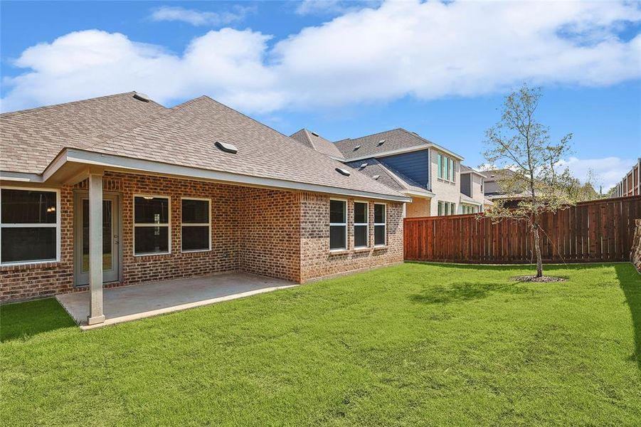 Back of property with a patio and a lawn