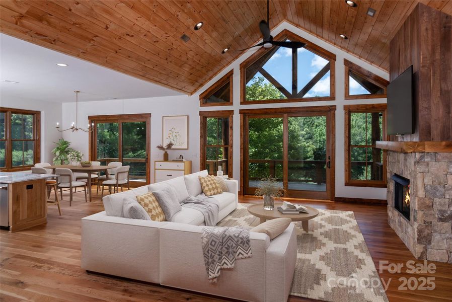 Vaulted living room with floor to ceiling sliding doors & windows and gas fireplace
