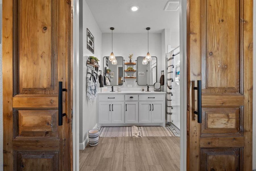 Bathroom with hardwood / wood-style floors and vanity