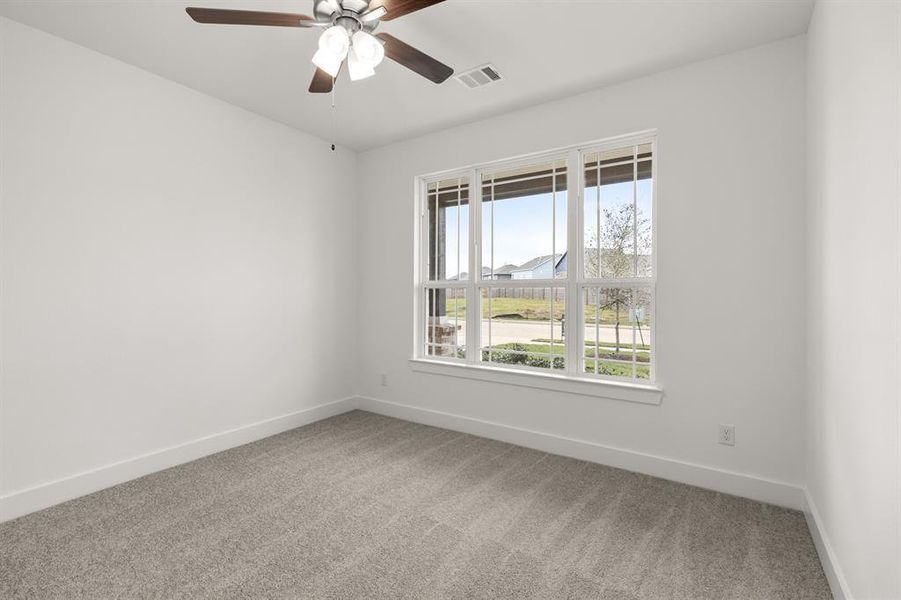 This secondary downstairs bedroom is a perfect space for a growing family, or even a parent to stay!
