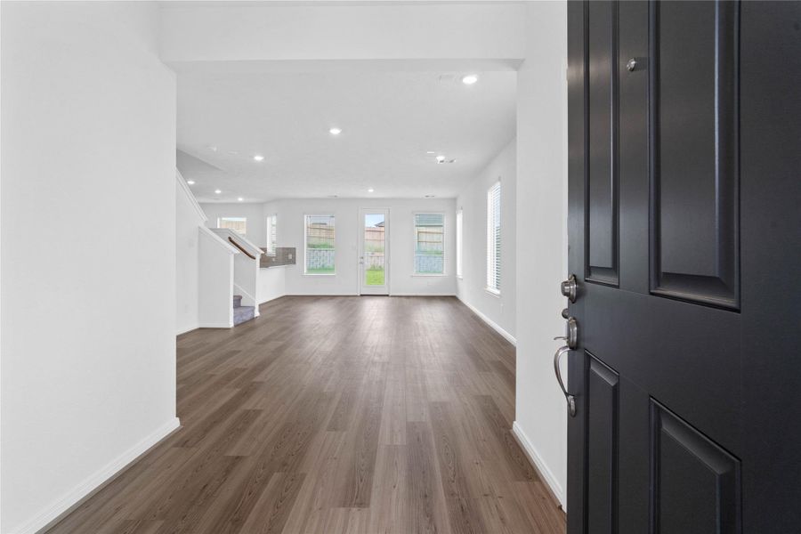 Walking into this gorgeous home, you get a feel of just how open everything is, this space showcases high ceilings, recessed lighting, open spaces and fluid floor plan, custom paint for a cooling feel, vinyl plank flooring throughout. This home is absolutely beautiful!