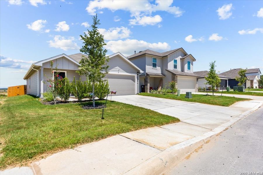 Front exterior of a new home in Redbird Ranch, San Antonio, TX, highlighting curb appeal (Image 24). Front exterior of a new home in Redbird Ranch, San Antonio, TX, highlighting curb appeal (Image 24).