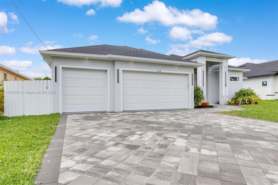 Front exterior of a new home in , Cape Coral, FL, highlighting curb appeal (Image 30). Front exterior of a new home in , Cape Coral, FL, highlighting curb appeal (Image 30).