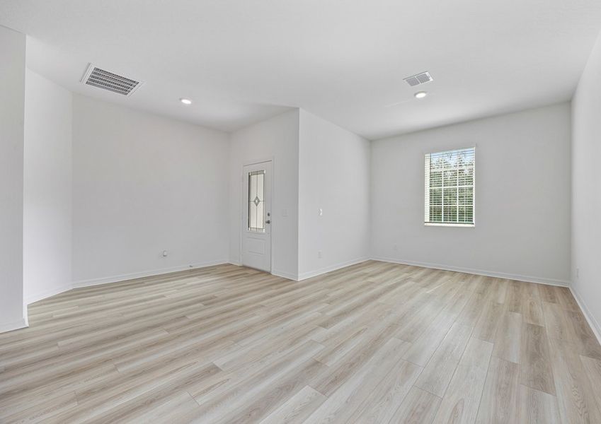 The flex room and adjoining dining room with vinyl flooring