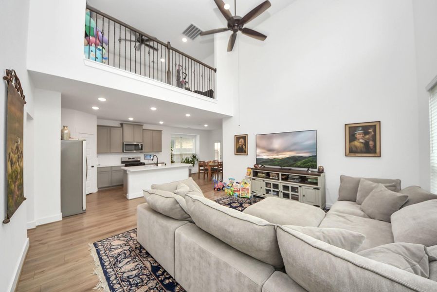 Bright living area with loft overlook and seamless flow to the kitchen.