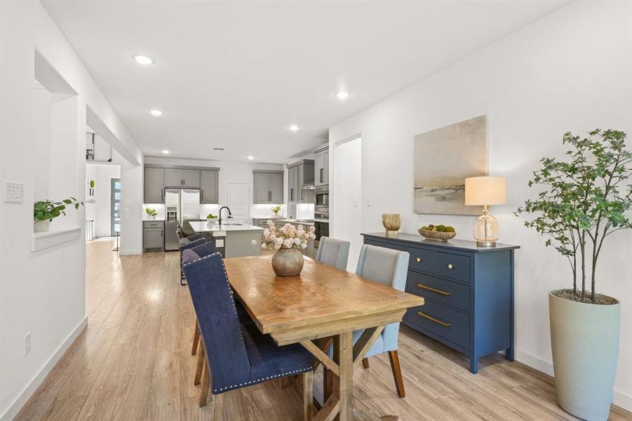 Dining area featuring light wood finished floors and recessed lighting