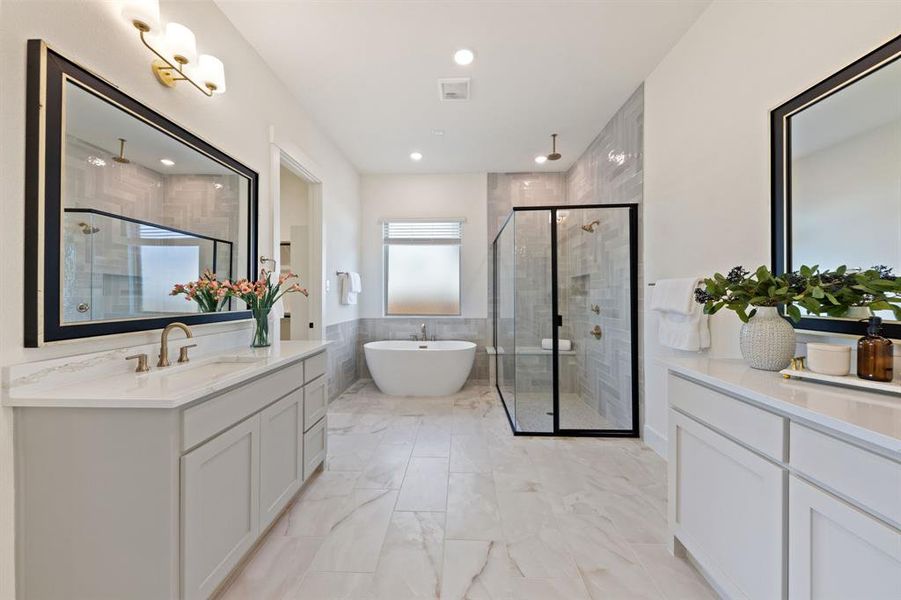 Featuring his and her vanities, you will enjoy ample room for two in this beautifully designed and finished owner's bath.