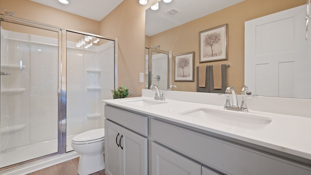 Notable primary suite with dual vanities and walk-in shower in this prime Anderson villa