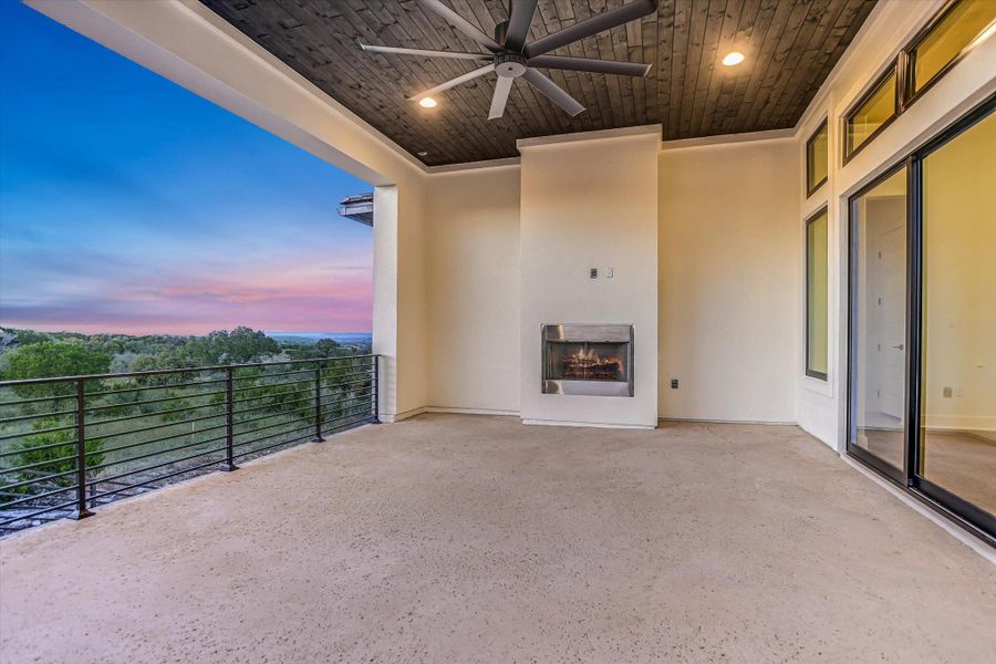View of patio featuring a fireplace and a ceiling fan