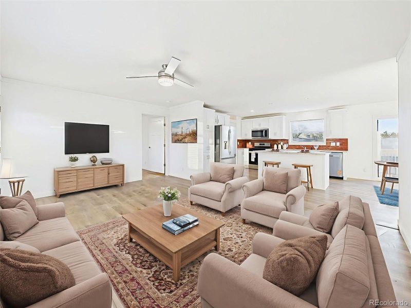 Family Room Virtually Staged This flexible main room showcases potential for multiple seating zones with direct views into the kitchen and dining areas.
