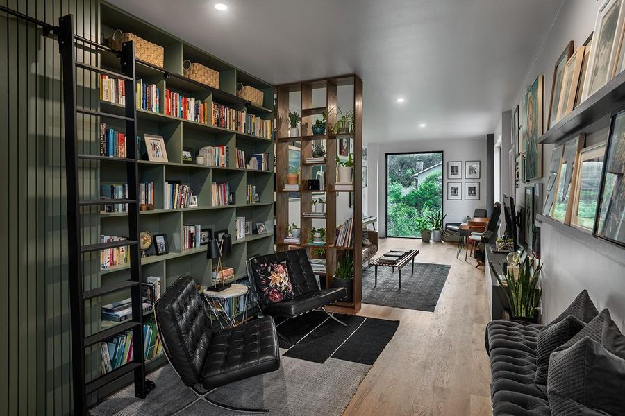 Sitting room with built in bookcase leading to hidden room.