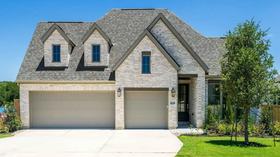 View of front facade featuring a shingled roof, driveway, an attached garage, and a front yard View of front facade featuring a shingled roof, driveway, an attached garage, and a front yard
