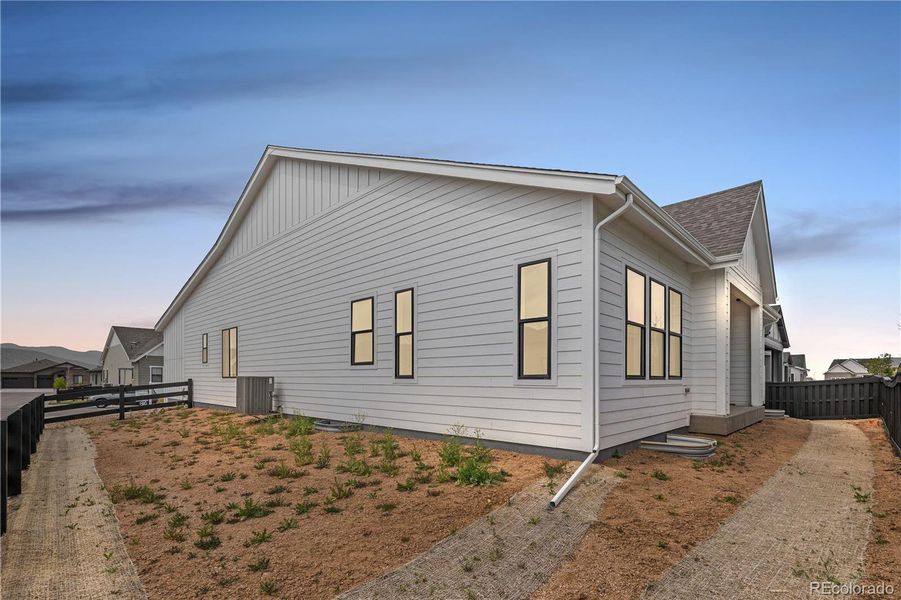 Front exterior of a new home in Reflection at Solstice, Littleton, CO, highlighting curb appeal (Image 25).