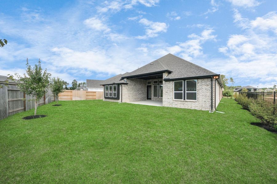 Front exterior of a new home in ARTAVIA: Hilltop Collection, Conroe, TX, highlighting curb appeal (Image 18). Front exterior of a new home in ARTAVIA: Hilltop Collection, Conroe, TX, highlighting curb appeal (Image 18).