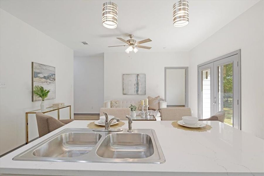 Kitchen with ceiling fan, sink, and decorative light fixtures