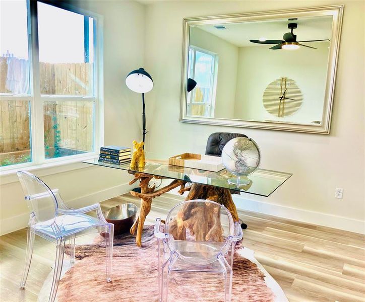 Chic home office nook with stylish accents and ample natural light.