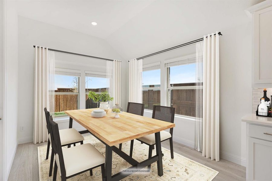 Bright dining room with wood table, four chairs, large windows, and light hardwood floors Bright dining room with wood table, four chairs, large windows, and light hardwood floors