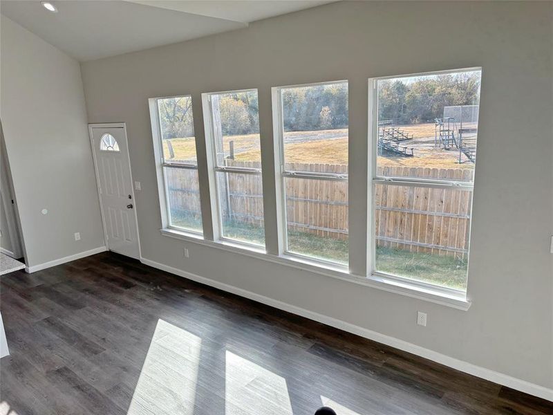 Foyer entrance with baseboards and dark wood finished floors