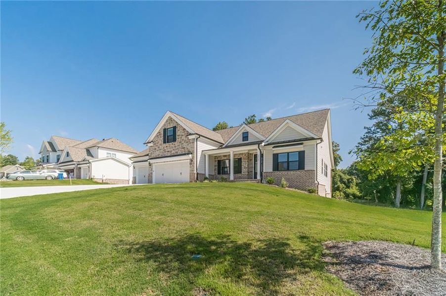 Front exterior of a new home in , Loganville, GA, highlighting curb appeal (Image 24).