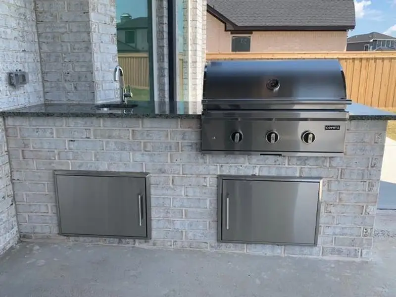 Exterior details and patio area of a home in Dunham Pointe, Cypress (Image 3).