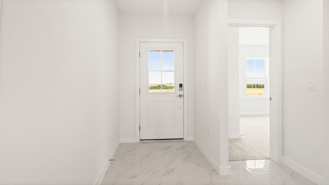 Bright entryway with marble-style tile flooring and natural light in the Castaway model