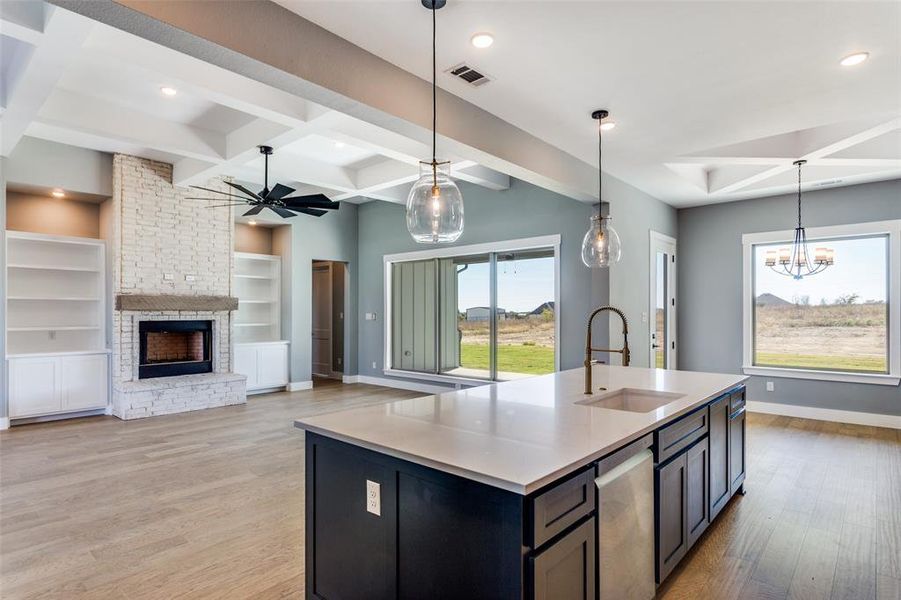 Kitchen with ceiling fan, decorative light fixtures, light wood-type flooring, plenty of natural light, and beamed ceiling Kitchen with ceiling fan, decorative light fixtures, light wood-type flooring, plenty of natural light, and beamed ceiling