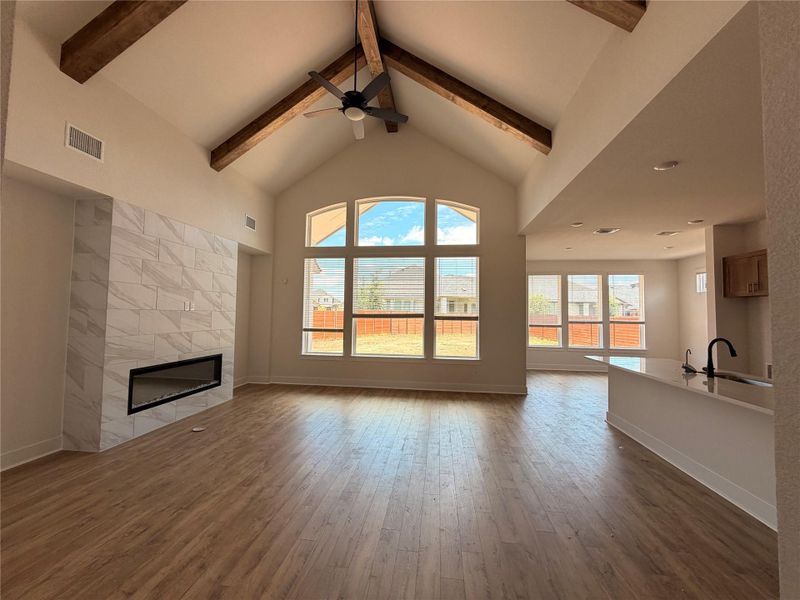 Natural light floods this great room, featuring high vaulted ceilings, rich hardwood flooring, and a contemporary fireplace. Natural light floods this great room, featuring high vaulted ceilings, rich hardwood flooring, and a contemporary fireplace.