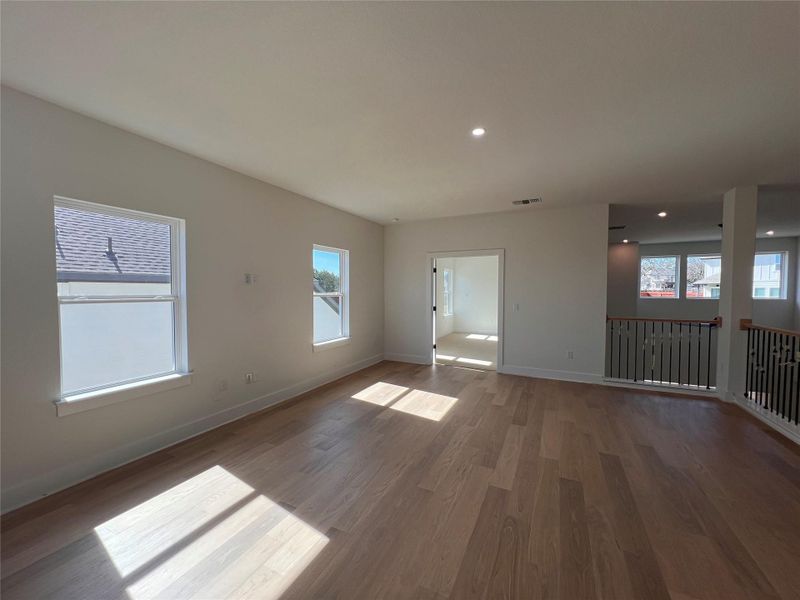 Empty room featuring wood finished floors and recessed lighting