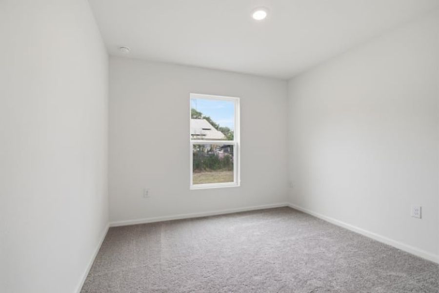 A room with a window and a carpet.