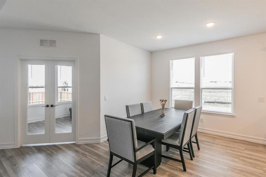 Dining area with hardwood / wood-style flooring