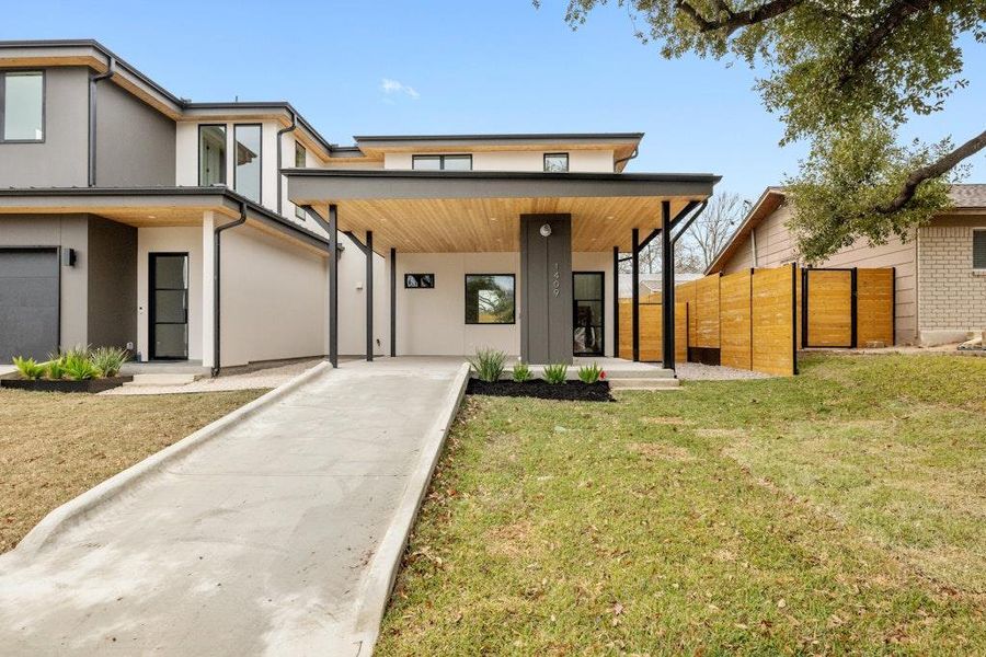 Contemporary house featuring covered porch and stucco siding