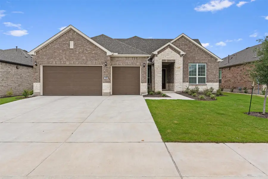 Front exterior of a new home in Sun City Texas, Georgetown, TX, highlighting curb appeal (Image 2).