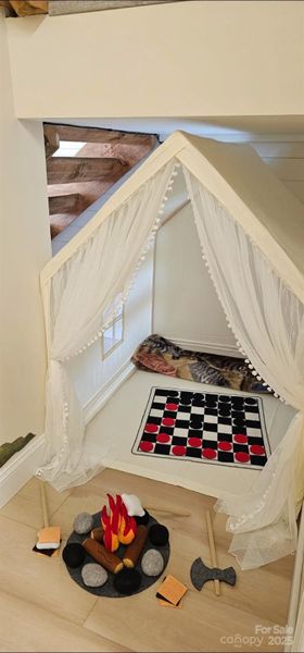 Cozy play nook under stairs in basement