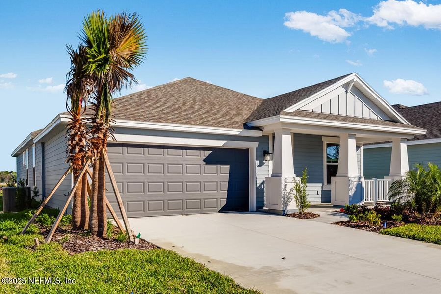 Front exterior of a new home in Colbert Landings, Palm Coast, FL, highlighting curb appeal (Image 1).